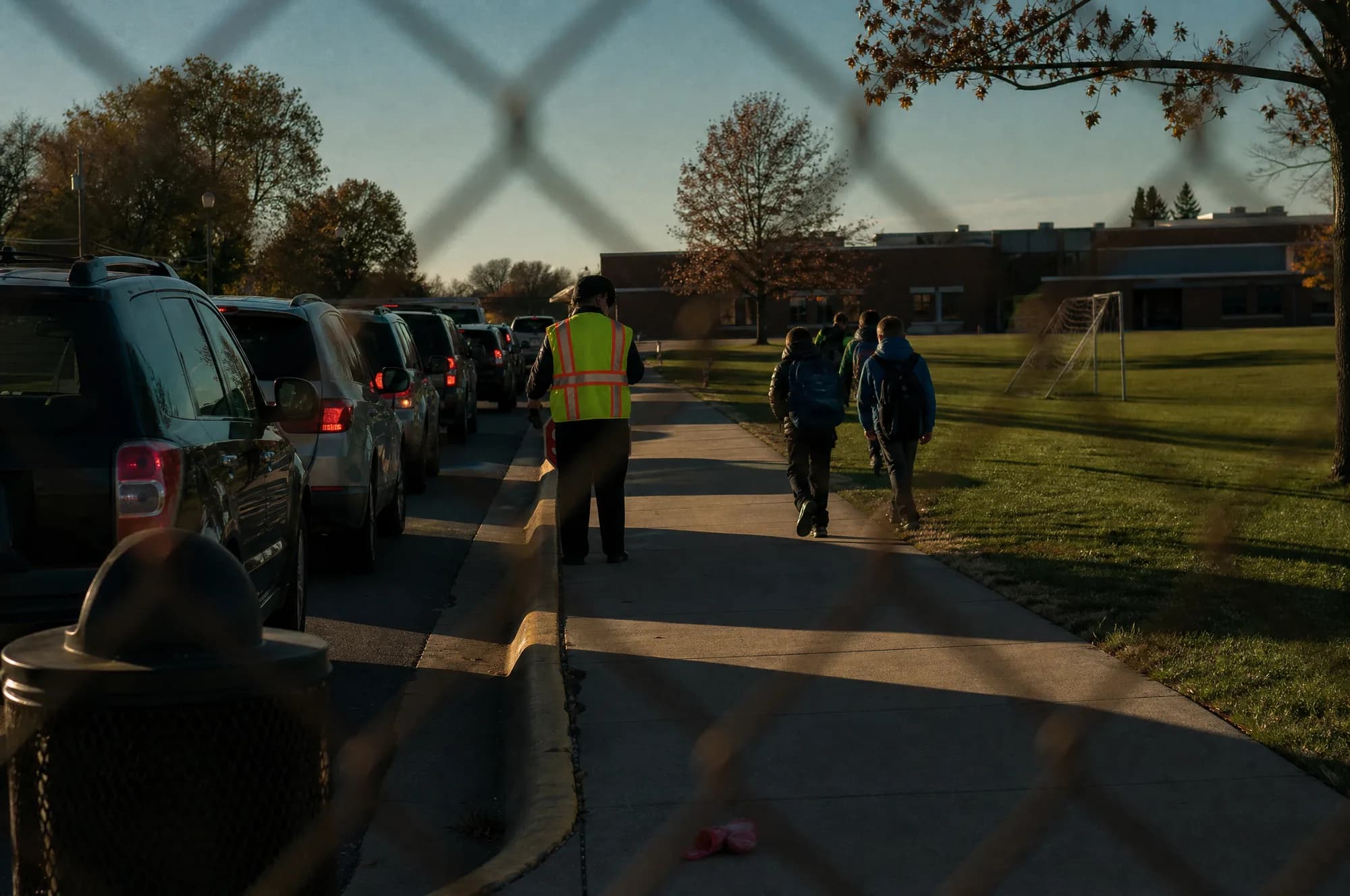 The pickup line outside a Kansas City-area school: a queue of cars along the curb, parents waiting at the end of the day.